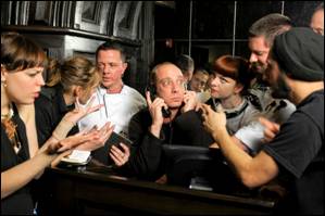 Gabriel Kuttner, center, in "Fully Committed."