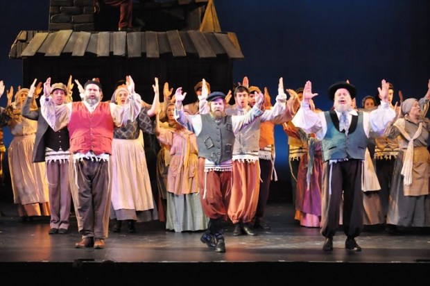 Scott Wahle as Tevye leads the company in "Tradition." Photo (c) Herb Philpott.
