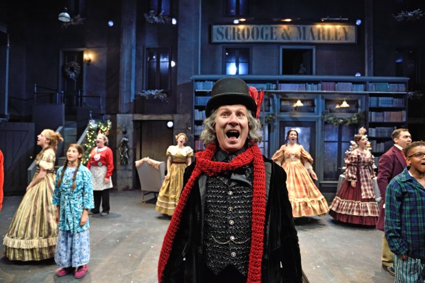 Brian McEleney as Ebenezer Scrooge with the ensemble of A Christmas Carol,directed James Dean Palmer at Trinity Rep. Set design by Michael McGarty, lighting design by Seth Reiser, costume design by Michael Krass. Photo Mark Turek. 
